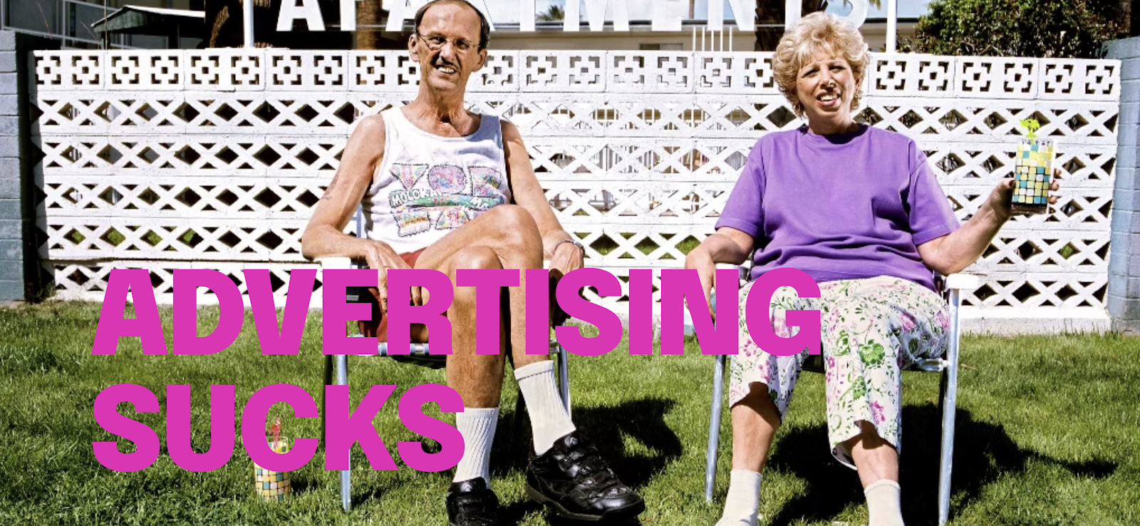 A couple seated in lawn chairs with the words Advertising Sucks